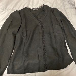 A long sleeve black blouse perfect for business.